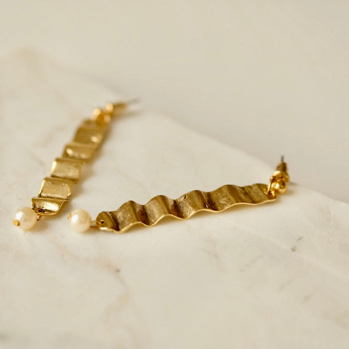 Tillydoro wave and pearl earrings featuring delicate silver waves with hanging white pearls, elegant and lightweight jewelry.