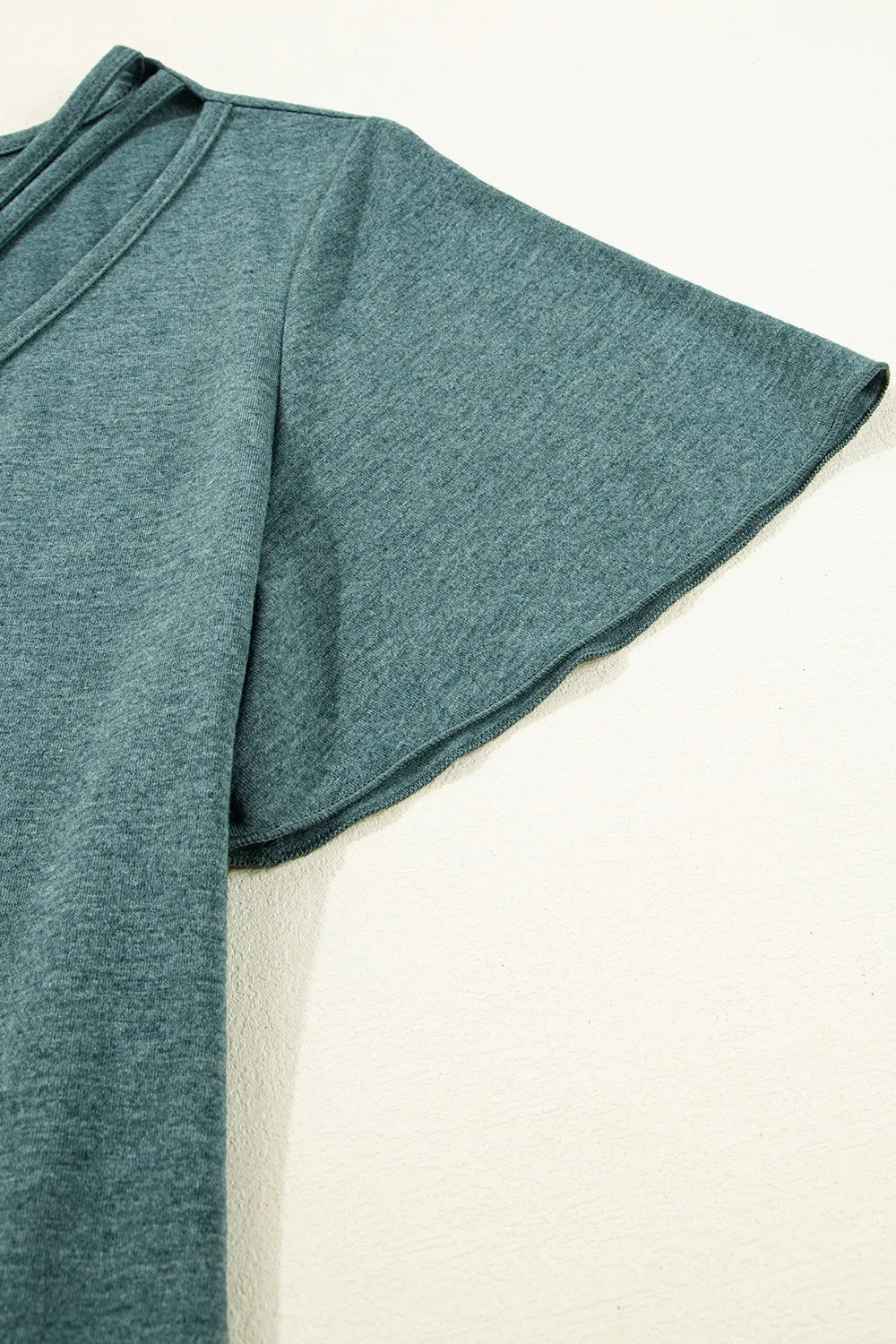 White classic V-neck tee by Trendsi, casual blouse with short sleeves and soft fabric, shown on a hanger.