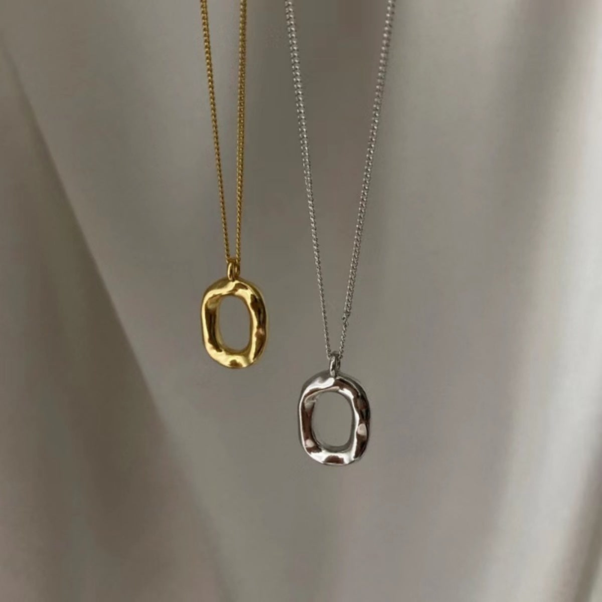 Sterling silver geometric pendant necklace with 18K gold plating, stylish and modern jewelry design.
