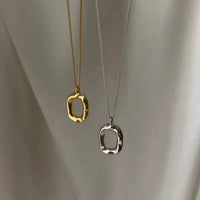Sterling silver geometric pendant necklace with 18K gold plating, stylish and modern jewelry design.
