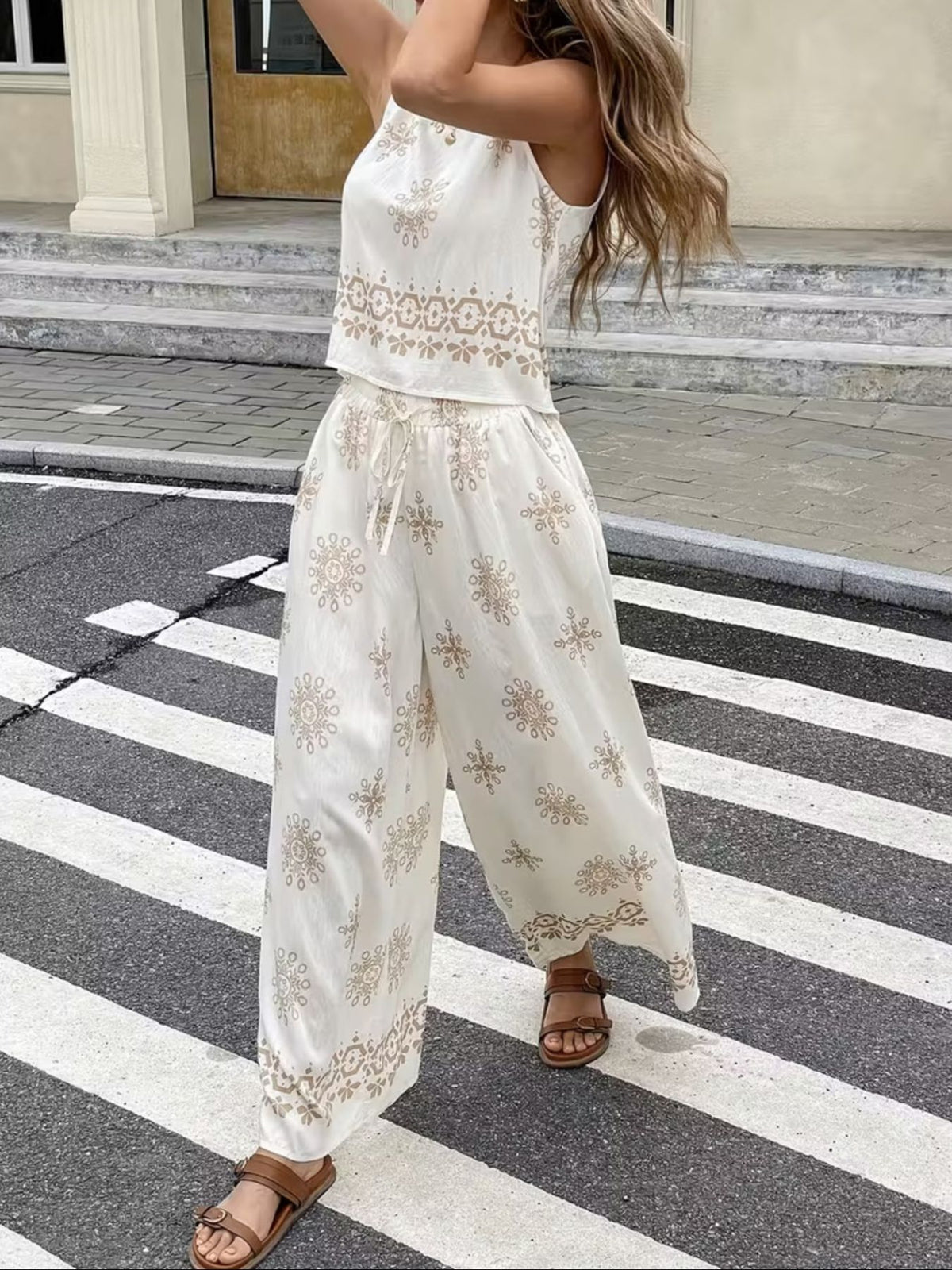 Sleeveless top and wide-leg pants set by Trendsi, featuring a stylish two-piece outfit with a sleeveless top and flowy pants.