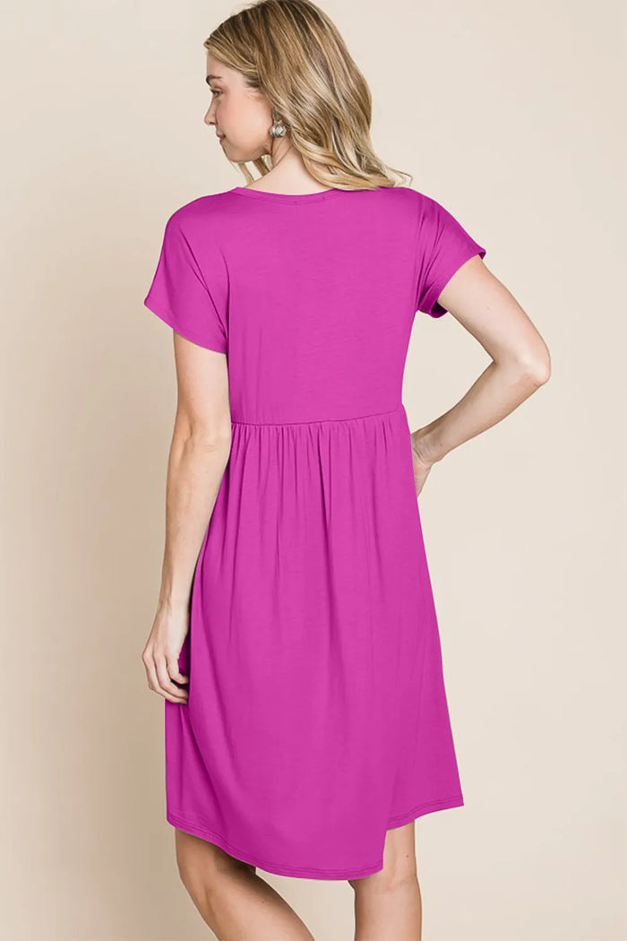 V-neck button front dress in soft fabric, featuring long sleeves and a flattering fit, styled for casual or semi-formal wear.