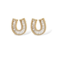 Sparkling horseshoe-shaped jewelry set with AAA cubic zirconia in gold-plated and white gold finishes on cream background.