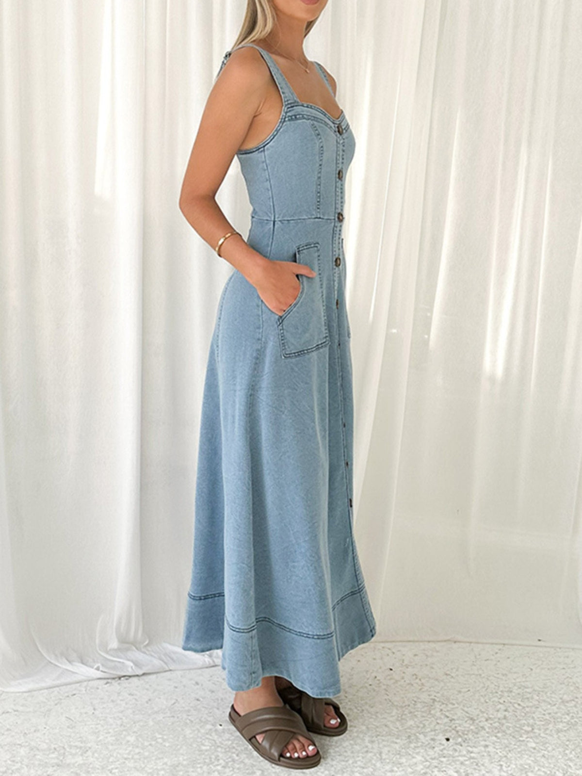 Decor button front A-line denim dress by Trendsi, featuring a classic fit with stylish button details and a flattering silhouette.