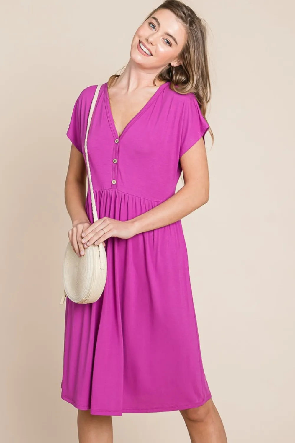 V-neck button front dress from Trendsi, featuring a stylish design with a flattering fit and elegant silhouette.