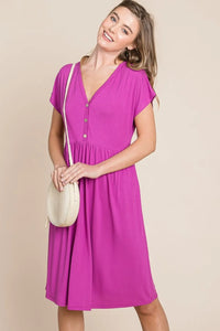 V-neck button front dress from Trendsi, featuring a stylish design with a flattering fit and elegant silhouette.