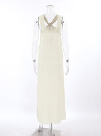 Elegant black halter neck maxi dress by Trendsi featuring a flowing silhouette and sleeveless design.