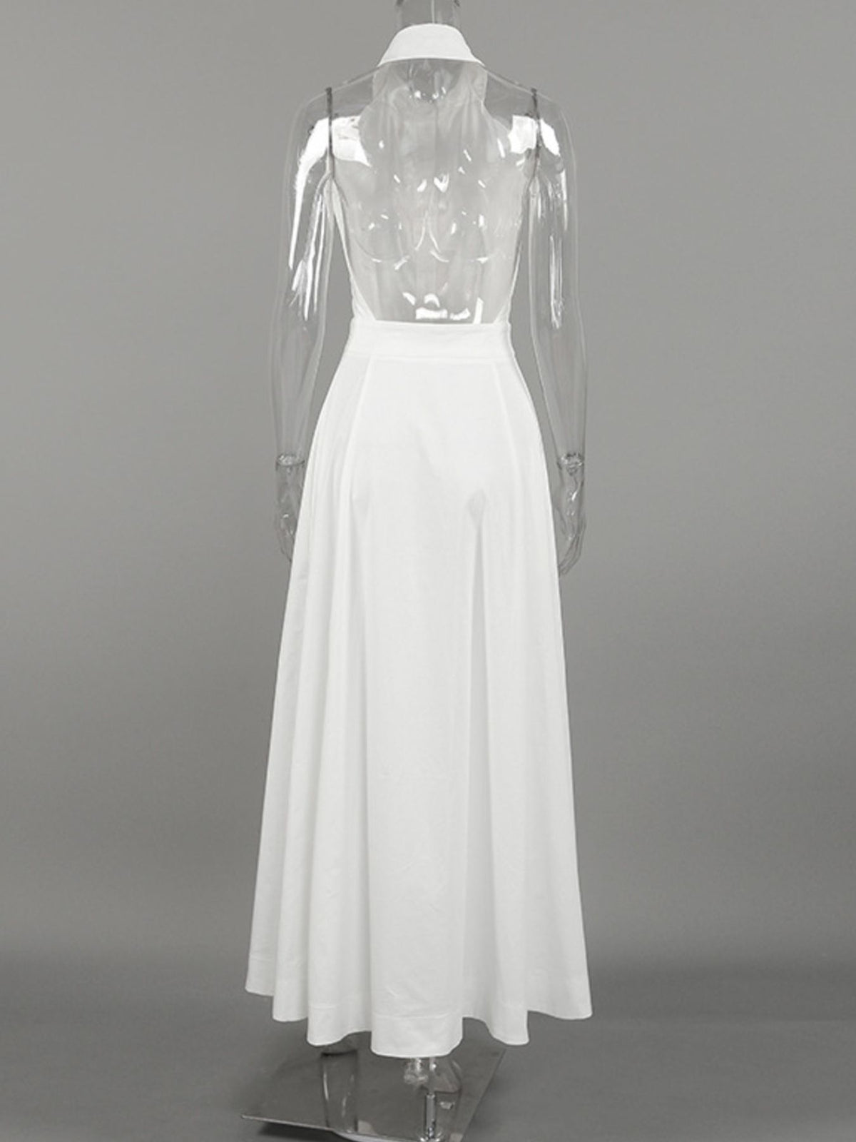 Backless button-front maxi dress by Trendsi, flowing fabric with a high slit, sleeveless design, and elegant backless style.