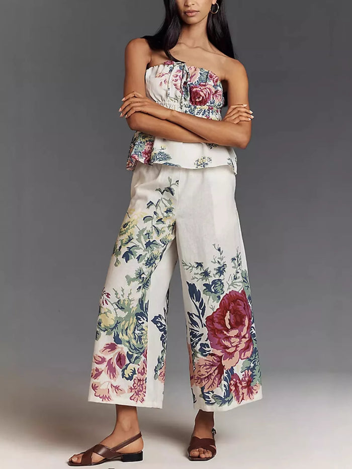 Floral print strapless top and wide-leg pants set by Trendsi, featuring a stylish two-piece outfit with vibrant floral patterns.