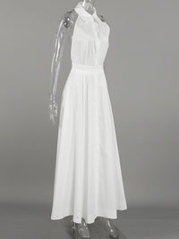 Backless button-front maxi dress from Trendsi featuring a flowing silhouette and elegant design, displayed on a model.