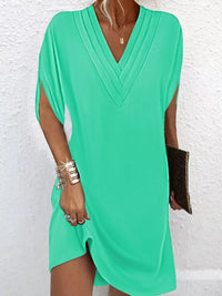 Trendsi plus size mini dress featuring a V-neck and slit sleeves in a stylish design.