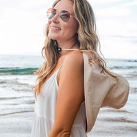 A person wearing a navy drawstring cargo hat from Aili's Corner, showcasing the adjustable brim and cargo-style design.