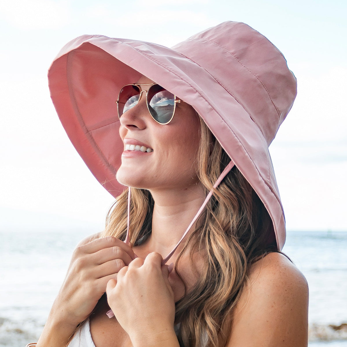 Aili's Corner drawstring cargo hat with adjustable straps and multiple pockets, styled as a versatile accessory for outdoor wear.