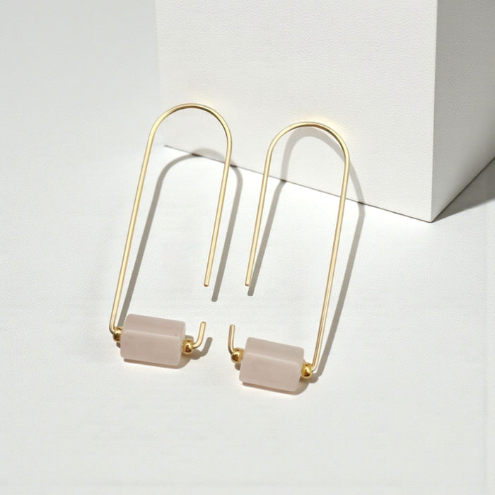 Gold and rose quartz earrings from Bijou by SAM, featuring elegant jewelry with sparkling rose quartz stones and gold accents.