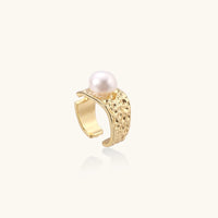 Wide gold-plated ring with organic textured band and white freshwater pearl centerpiece