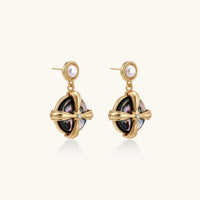Gold-plated drop earrings with iridescent abalone shell and pearl studs in geometric cross design