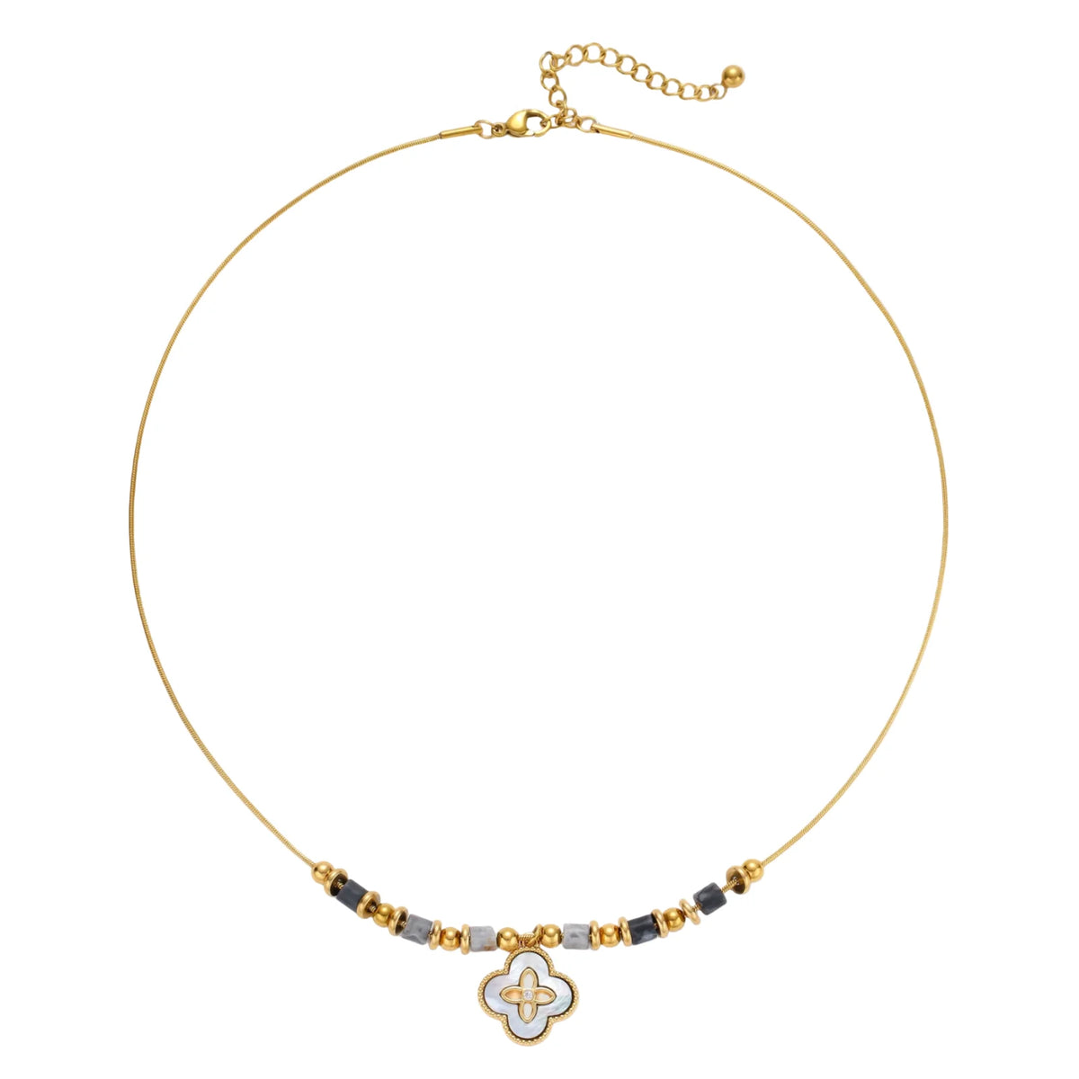 Gold-toned beaded necklace with grey stones and quatrefoil abalone shell pendant on cream background.