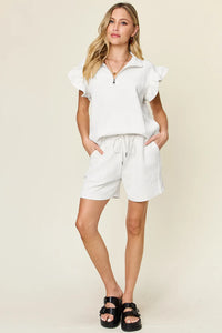 Two-piece set featuring a textured flounce sleeve top and matching drawstring shorts by Trendsi.
