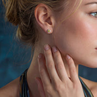 Sunburst halo stud earrings from The Glambox Jewels Boutique featuring gold-tone metal and sparkling gemstone accents.