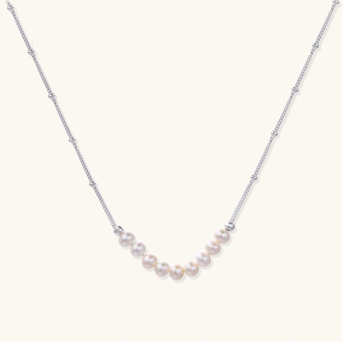 Luna Pearl Arc Necklace from The Glambox Jewels Boutique featuring a delicate arc design with luminous pearls on a fine chain
