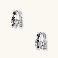 Triple-row white gold hoops with black X-pattern, twisted band, and pavé zirconia stones on white background.