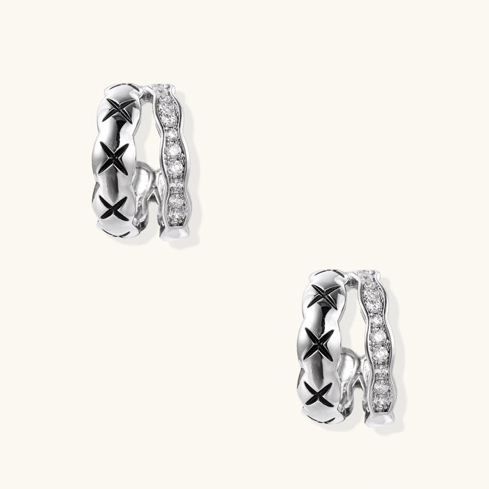 Triple-row white gold hoops with black X-pattern, twisted band, and pavé zirconia stones on white background.