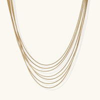 Gold layered necklace from The Glambox Jewels Boutique featuring delicate chain layers and elegant design.