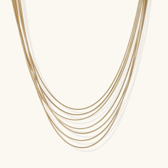 Gold layered necklace from The Glambox Jewels Boutique featuring delicate chain layers and elegant design.
