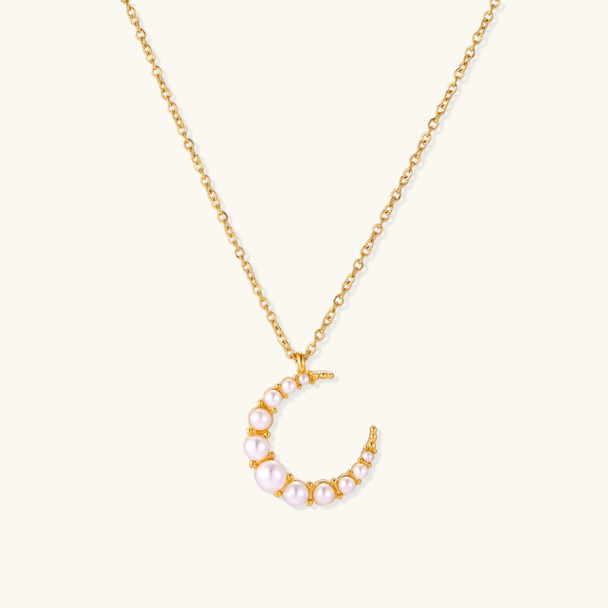 Luna Pearl Crescent Necklace from The Glambox Jewels Boutique featuring a delicate crescent shape with lustrous pearls.