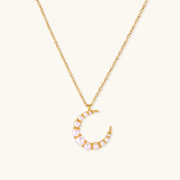 Luna Pearl Crescent Necklace from The Glambox Jewels Boutique featuring a delicate crescent shape with lustrous pearls.