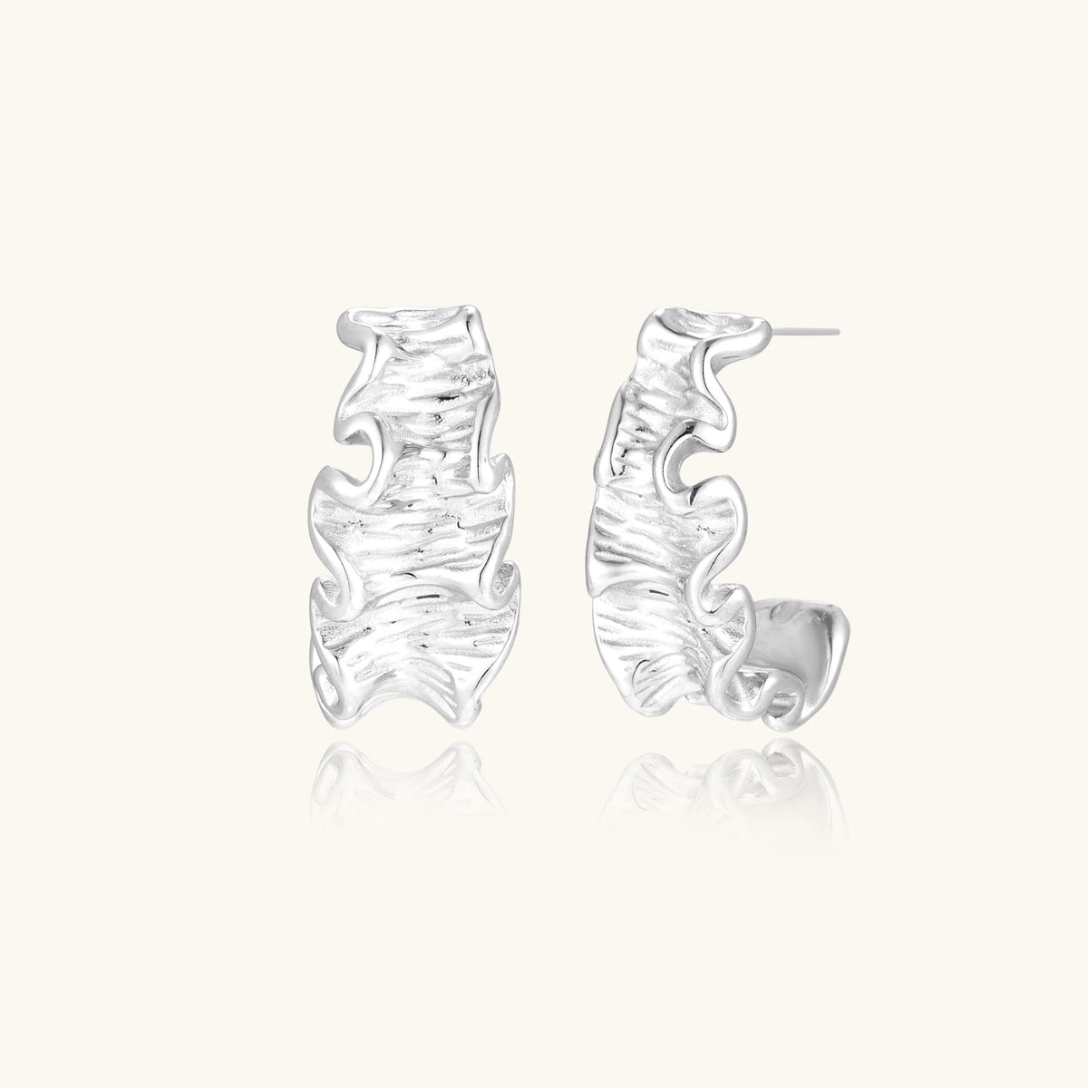 Ripple Wave Hoops earrings by The Glambox Jewels Boutique featuring silver-tone wave-shaped hoop earrings.