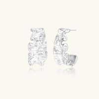 Ripple Wave Hoops earrings by The Glambox Jewels Boutique featuring silver-tone wave-shaped hoop earrings.