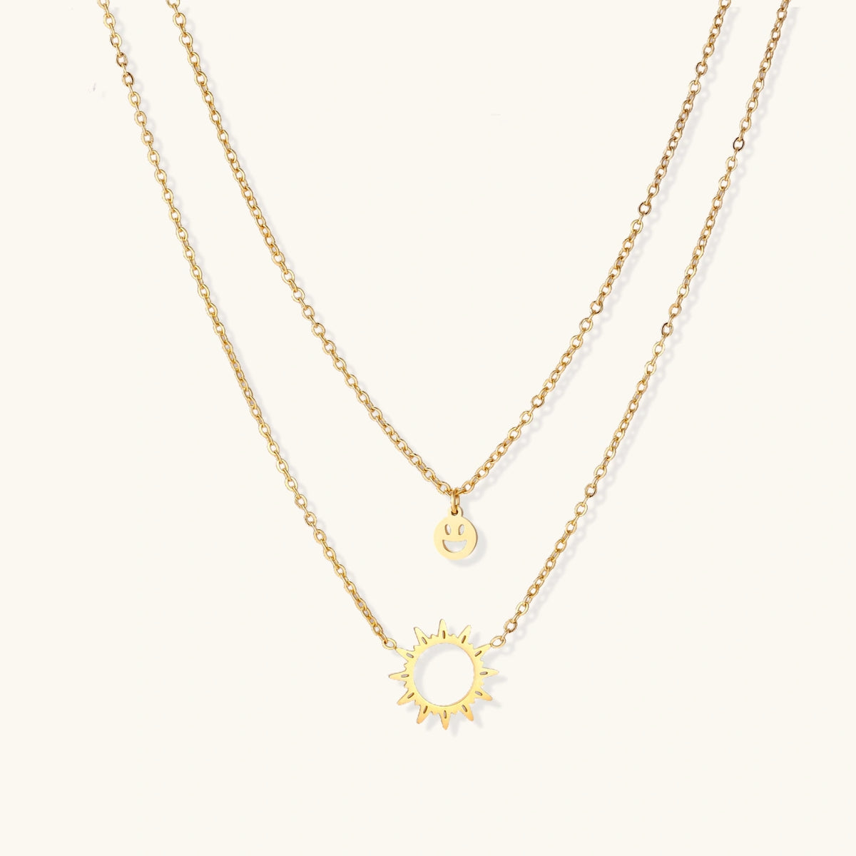 Gold layered Sunshine Smiley necklace by The Glambox Jewels Boutique featuring cheerful sun and smiley charm design.