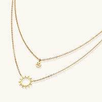 Sunshine Smiley layered necklace by The Glambox Jewels Boutique with cheerful smiley pendant and gold layered chain on a neutral background