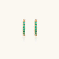 Emerald Energy Huggies earrings by The Glambox Jewels Boutique featuring vibrant green gemstone hoops on a silver setting.