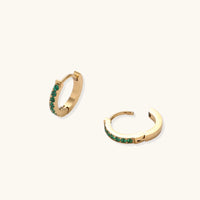 Emerald Energy Huggies earrings from The Glambox Jewels Boutique featuring vibrant green gemstone hoops.