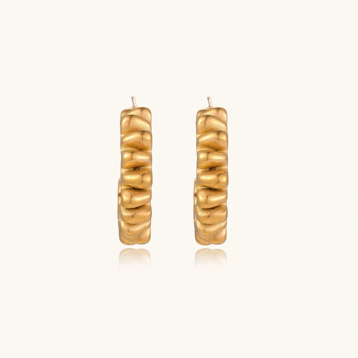 Gold twisted hoop earrings from The Glambox Jewels Boutique, featuring a stylish and elegant design.