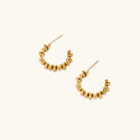 Twisted gold hoop earrings from The Glambox Jewels Boutique with a sleek, modern design and polished finish.