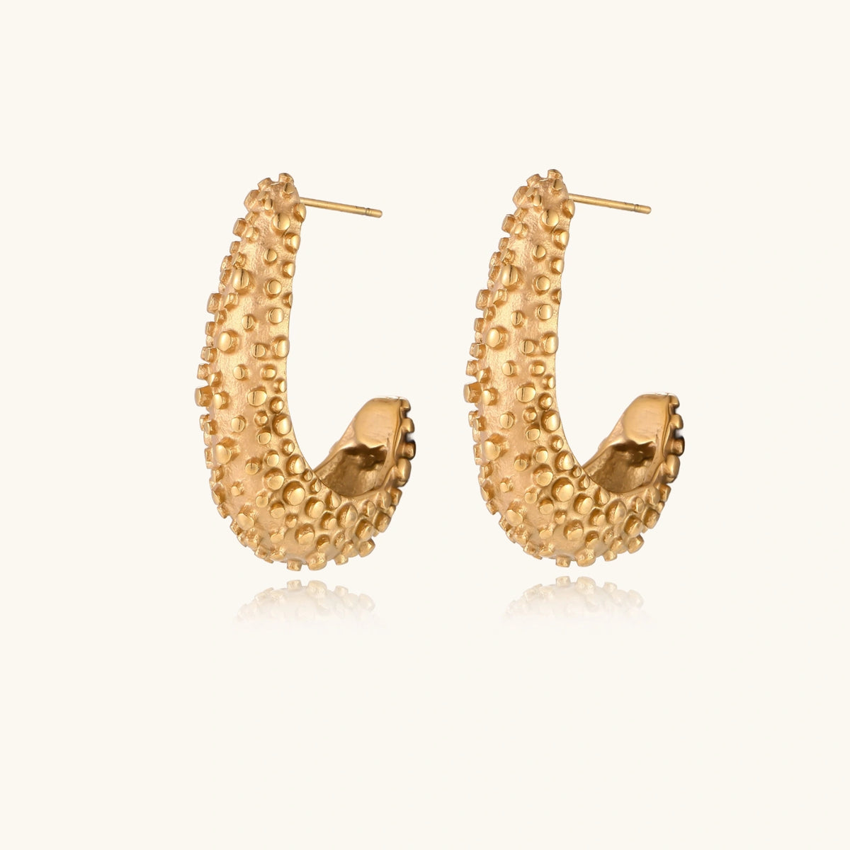Textured crescent hoop earrings from The Glambox Jewels Boutique, stylish gold-tone jewelry with a unique crescent design.