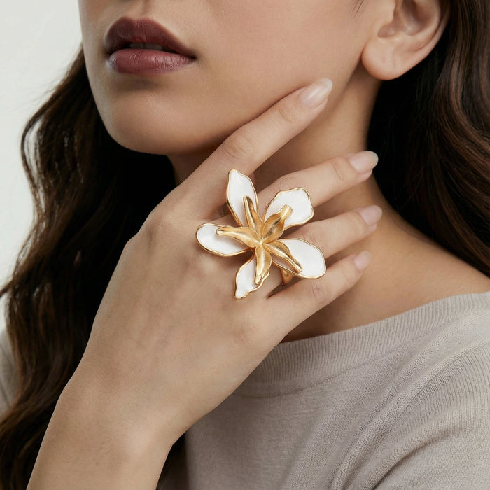 Lily Bloom ring from The Glambox Jewels Boutique featuring a delicate gold band with floral design and sparkling gemstone accents.