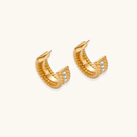 Twisted Confidence Hoops earrings by The Glambox Jewels Boutique featuring sleek, twisted gold-tone design on shiny hoops.
