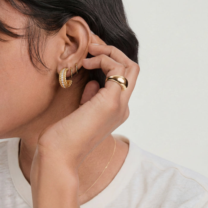 Twisted Confidence Hoops earrings by The Glambox Jewels Boutique featuring bold, twisted metal design in gold tone.