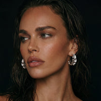 Ripple Wave Hoop Earrings by The Glambox Jewels Boutique, showcasing stylish gold-tone hoops with a textured wave design