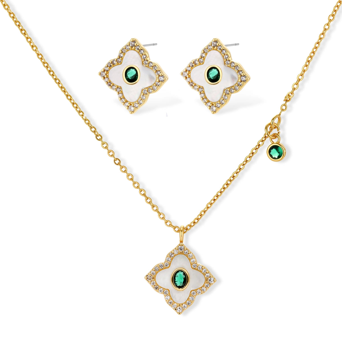 Gold-plated quatrefoil pendant and earrings with white enamel, emerald CZ center stones, and crystal borders on white background.