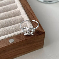 Silver Eternal Knot Heart Ring by Trendsi featuring a delicate heart-shaped design with an intricate knot pattern.