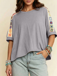 Square crochet detail loose T-shirt from Trendsi, featuring a relaxed fit and crochet accents in a casual blouse style.