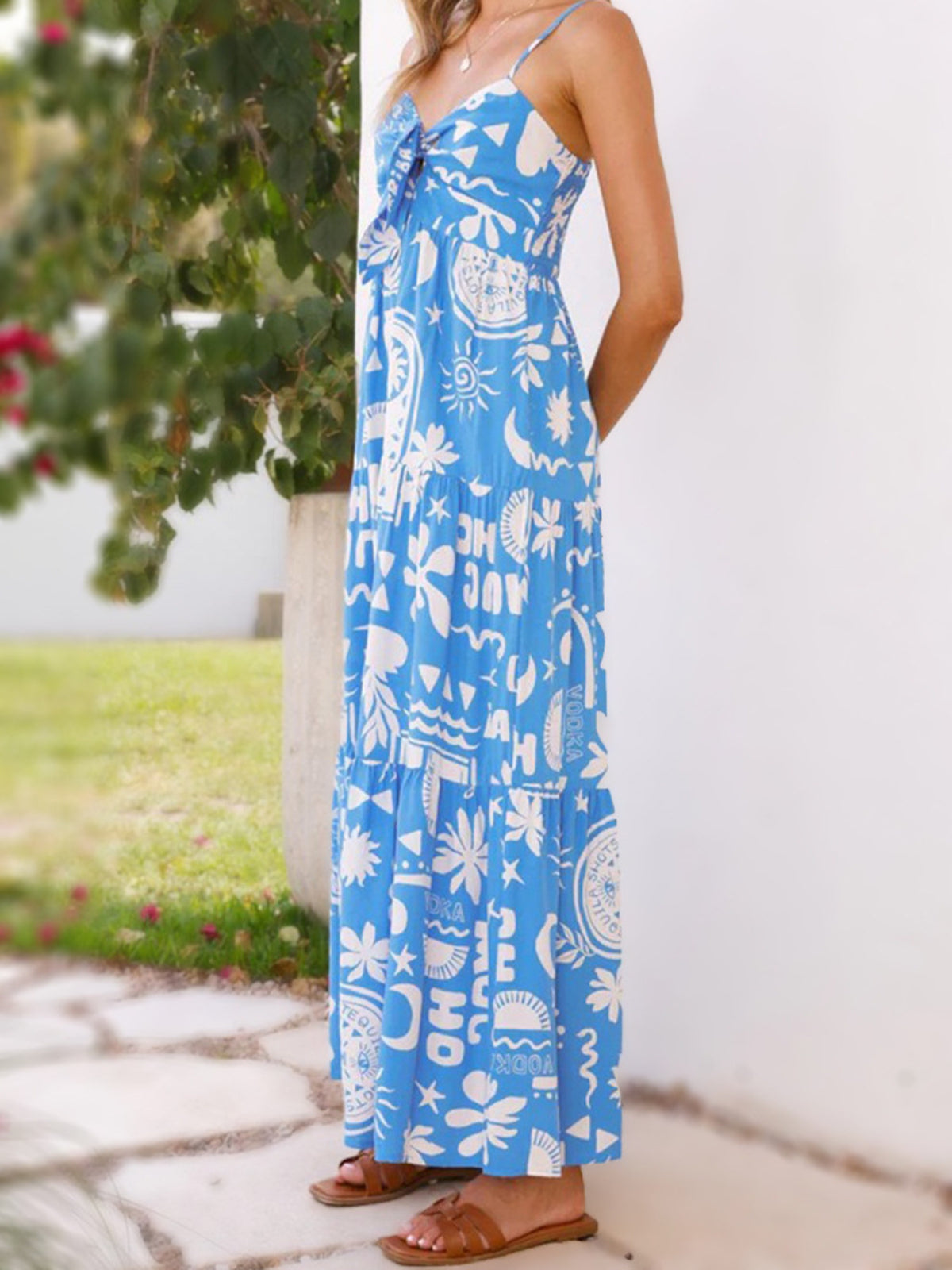 Tie-front print maxi dress from Trendsi featuring a flowy silhouette, vibrant floral pattern, and adjustable waist tie.