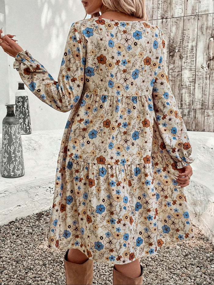 Floral print long sleeve tiered dress by Trendsi, featuring a flowy design with layered tiers and vibrant floral pattern.