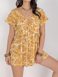 Ruffled print romper from Trendsi featuring a stylish jumpsuit design with floral print and ruffled details.
