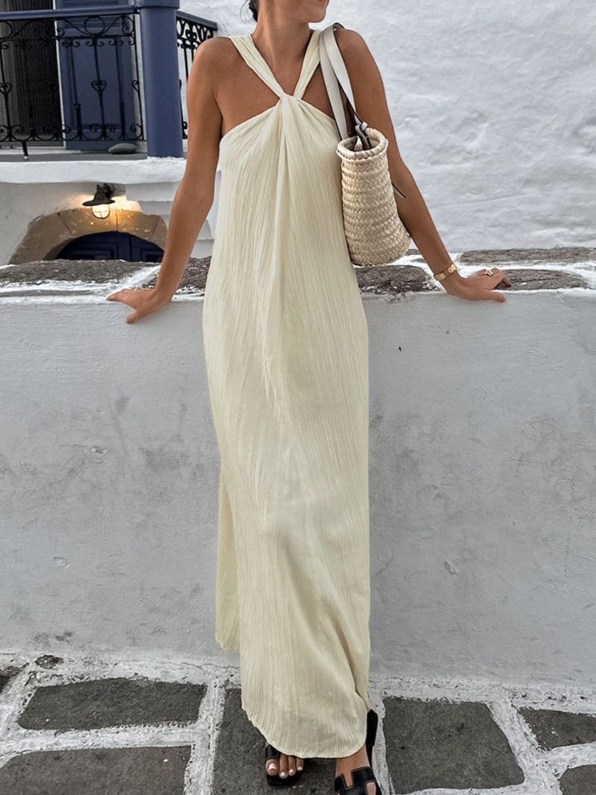 Trendsi halter neck maxi dress featuring a flowing silhouette, sleeveless design, and elegant fabric for a stylish summer look.